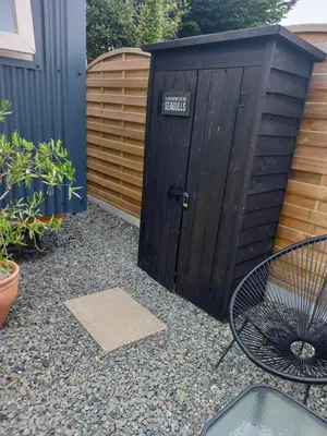 a black shed with a sign that says secrets at Stargazy Shepherds Hut in St Ives