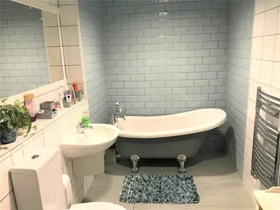 a bathroom with a tub and a sink and a toilet at Beautiful 3 bedroom apartment by the Sea in Newquay