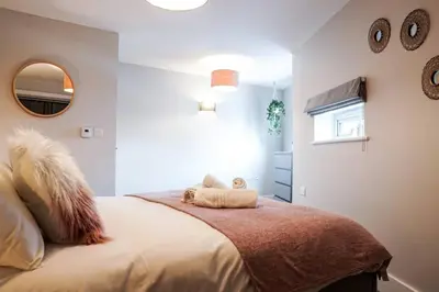 a bedroom with a bed with two stuffed animals on it at Beautiful 3 bedroom apartment by the Sea in Newquay