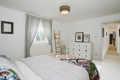 a bedroom with a bed and a window and a dresser at Finest Retreats - Atlantic Hideaway in Newquay