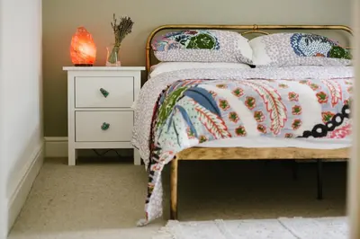 a bed with a quilt and pillows on it at Finest Retreats - Atlantic Hideaway in Newquay