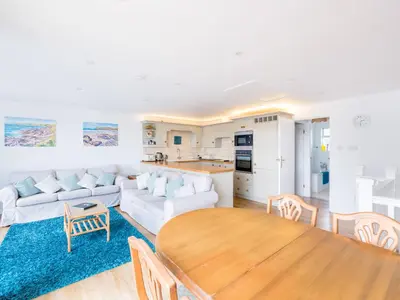 a living room with a white couch and a table at Slipway 21 in Padstow