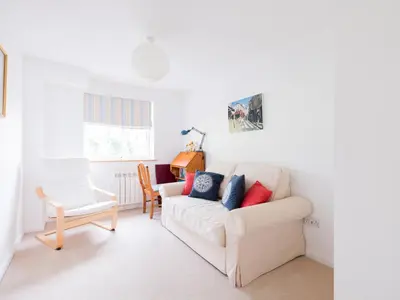 a living room with a white couch and a chair at Slipway 21 in Padstow