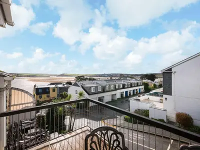 a balcony with a view of a river and buildings at Slipway 21 in Padstow