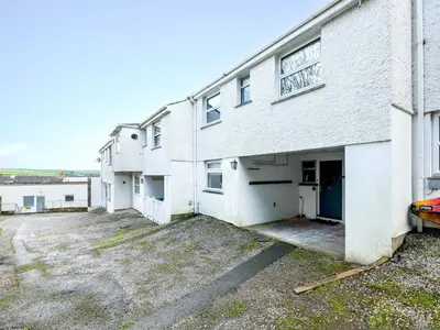 an empty parking lot in front of a white building at Slipway 21 in Padstow