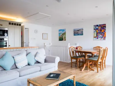 a living room with a couch and a table at Slipway 21 in Padstow