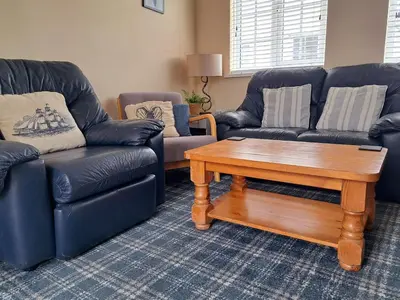 a living room with two couches and a coffee table at Seven Bays Stays in St Merryn