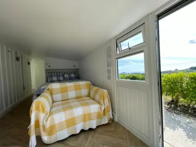 a bedroom with a bed and a window at Mount View Overnight Accommodation in Penzance