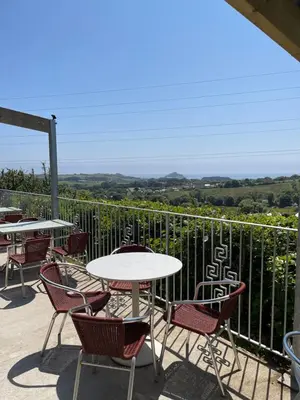 a table and chairs on a patio with a view at Mount View Overnight Accommodation in Penzance