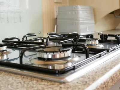 a gas stove top with four burners on it at Stowaway St Merryn in St Merryn