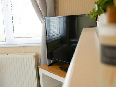 a flat screen tv sitting on top of a table at Stowaway St Merryn in St Merryn