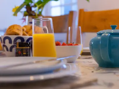 a table with a bowl of fruit and a glass of orange juice at Trengoff in St Ives