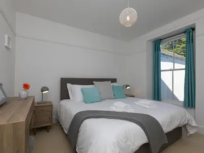 a bedroom with a large bed and a window at Trengoff in St Ives