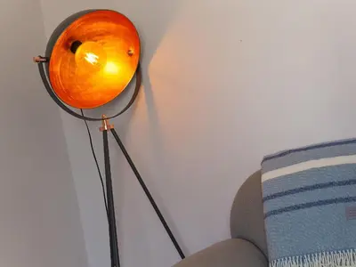 a orange lamp sitting next to a couch at Trengoff in St Ives
