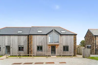 a barn style house with a slate roof at Cedar House in St. Agnes
