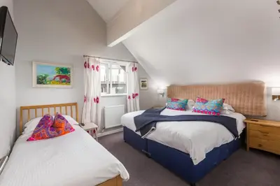 a bedroom with two beds and a window at Lodge 27 - Resort & Spa - Parking - Private Hot Tub in Saint Columb Major