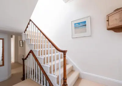 a staircase in a home with white walls at The Terrace 2 in Padstow