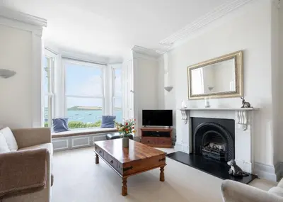 a living room with a fireplace and a television at The Terrace 2 in Padstow