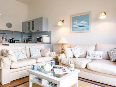 a living room with two white couches and a coffee table at Slipway 12 in Padstow