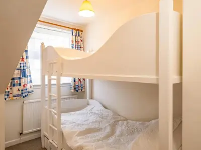 a white bunk bed in a room with a window at Slipway 12 in Padstow