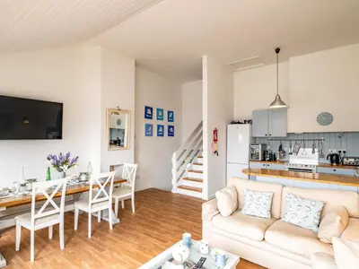 a living room with a couch and a table at Slipway 12 in Padstow