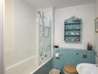 a bathroom with a shower and a toilet and a sink at Slipway 12 in Padstow