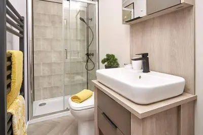 a bathroom with a sink and a shower and a toilet at Lowena Lodge - Padstow in Padstow