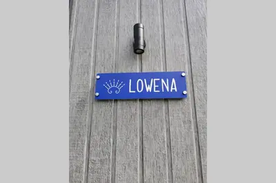 a blue sign on the side of a building at Lowena Lodge - Padstow in Padstow