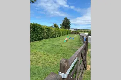 a park with a fence and a field of grass at Lowena Lodge - Padstow in Padstow