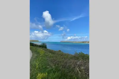 a view of a body of water from a hill at Lowena Lodge - Padstow in Padstow