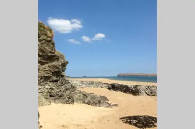 a view of a beach with rocks and the ocean at Lowena Lodge - Padstow in Padstow