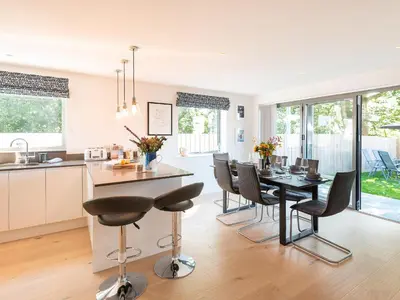 a kitchen and dining room with a table and chairs at Pentire in Saint Minver
