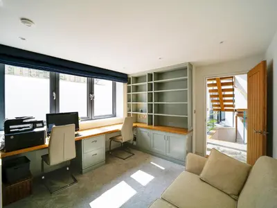 an office with a desk with a computer and a couch at Megizzy in Polzeath