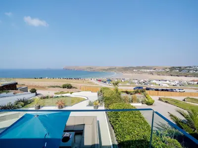 a view of the beach from the balcony of a house at Megizzy in Polzeath