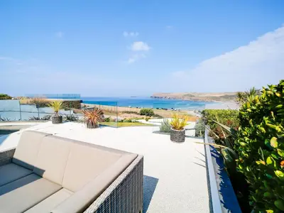 a view of the ocean from the balcony of a house at Megizzy in Polzeath