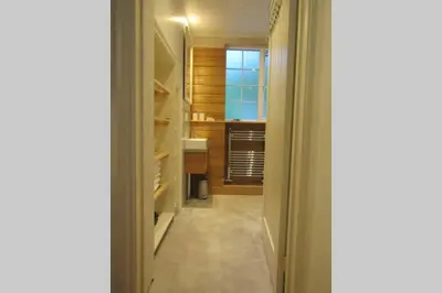 a hallway leading to a bathroom with a window at Lovely Spacious Cottage Near The Coast in St Austell