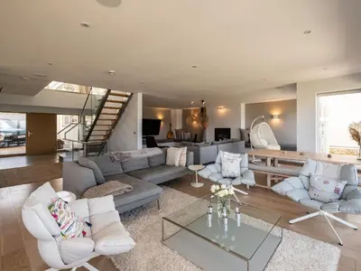 a living room with a couch and a table at Seascape in Polzeath