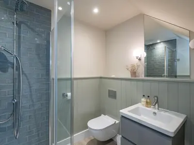 a bathroom with a toilet and a sink and a shower at Seascape in Polzeath