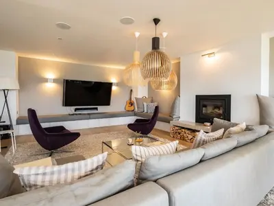 a living room with a couch and a tv at Seascape in Polzeath