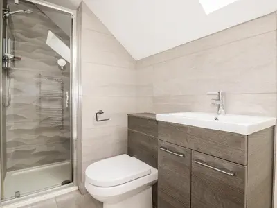 a bathroom with a toilet and a sink and a shower at 16 Ocean Heights in Newquay