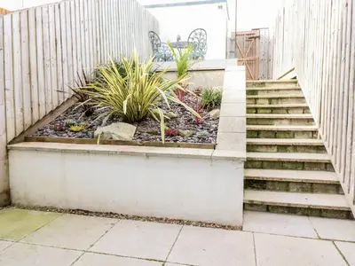 a set of stairs with plants in a garden at 16 Ocean Heights in Newquay