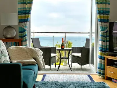 a living room with a view of the ocean at Little Chyryn Perranuthnoe in Perranuthnoe