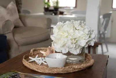 a vase filled with white flowers on a table at Swallow Cottage in Port Isaac