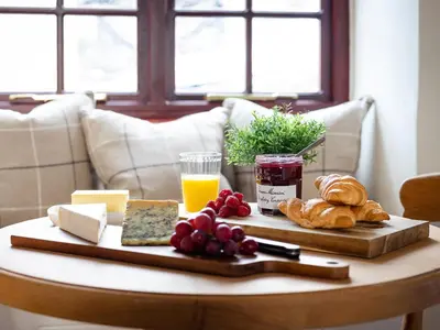 a table with a tray of breakfast foods on it at Swallow Cottage in Port Isaac