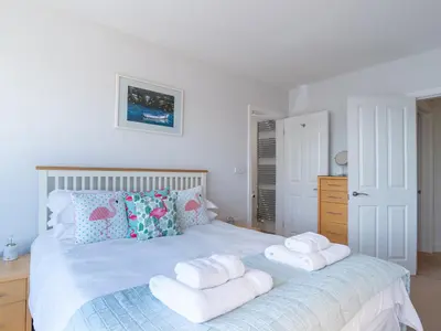 a bedroom with a bed with towels on it at Apartment 2 The Wheelhouse in Fowey