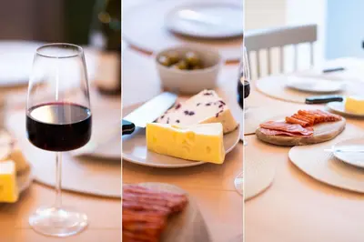 a table with a glass of wine and cheese at 23 Trenwith Place in St Ives