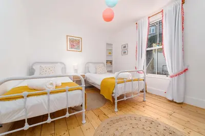 a bedroom with two beds and a window at 23 Trenwith Place in St Ives