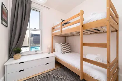 a bedroom with bunk beds and a window at 23 Trenwith Place in St Ives