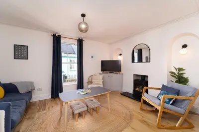 a living room with a couch and a table at 23 Trenwith Place in St Ives