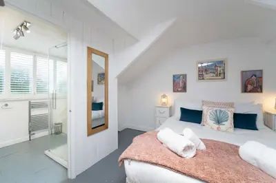 a bedroom with a bed with towels on it at Tregarth in St Ives